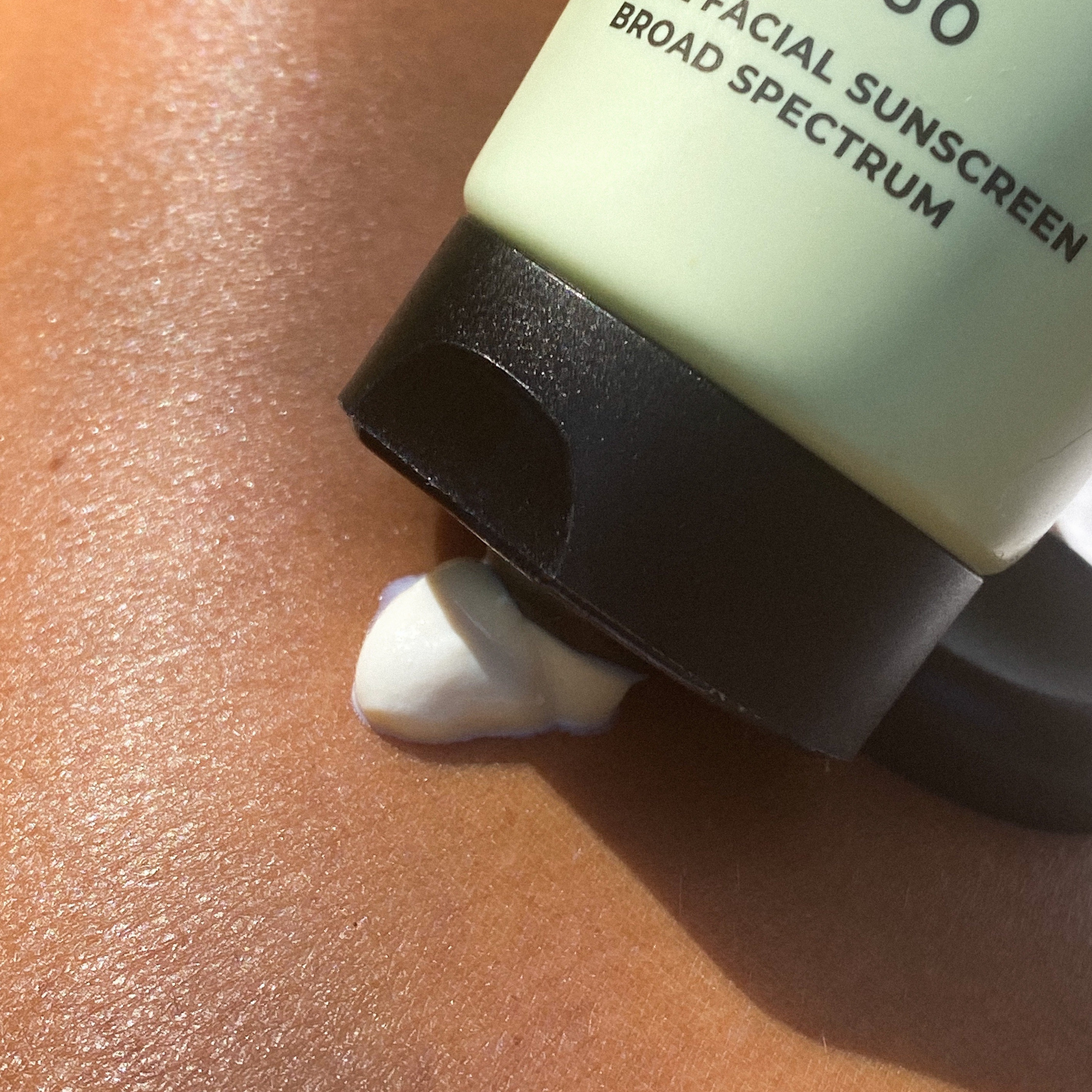 SPF 50 Natural Physical Sunscreen being dispensed from the tube, showing its lightweight formula.