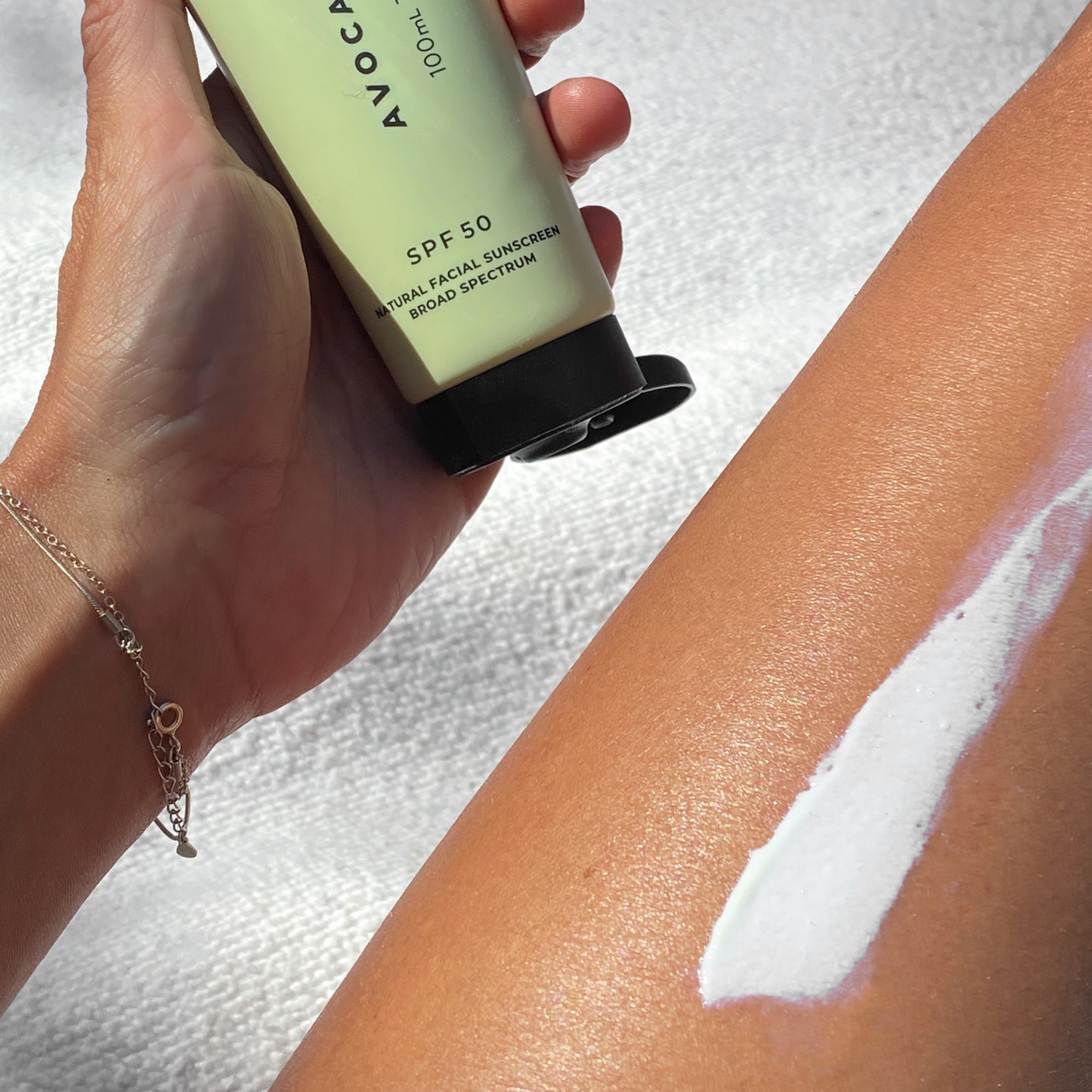 Close-up of SPF 50 Natural Physical Sunscreen swatched on skin, showing its smooth, non-greasy formula.